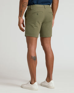 True Classic7 Military Green Classic Chino Shorts with welt pockets and white sneakers.