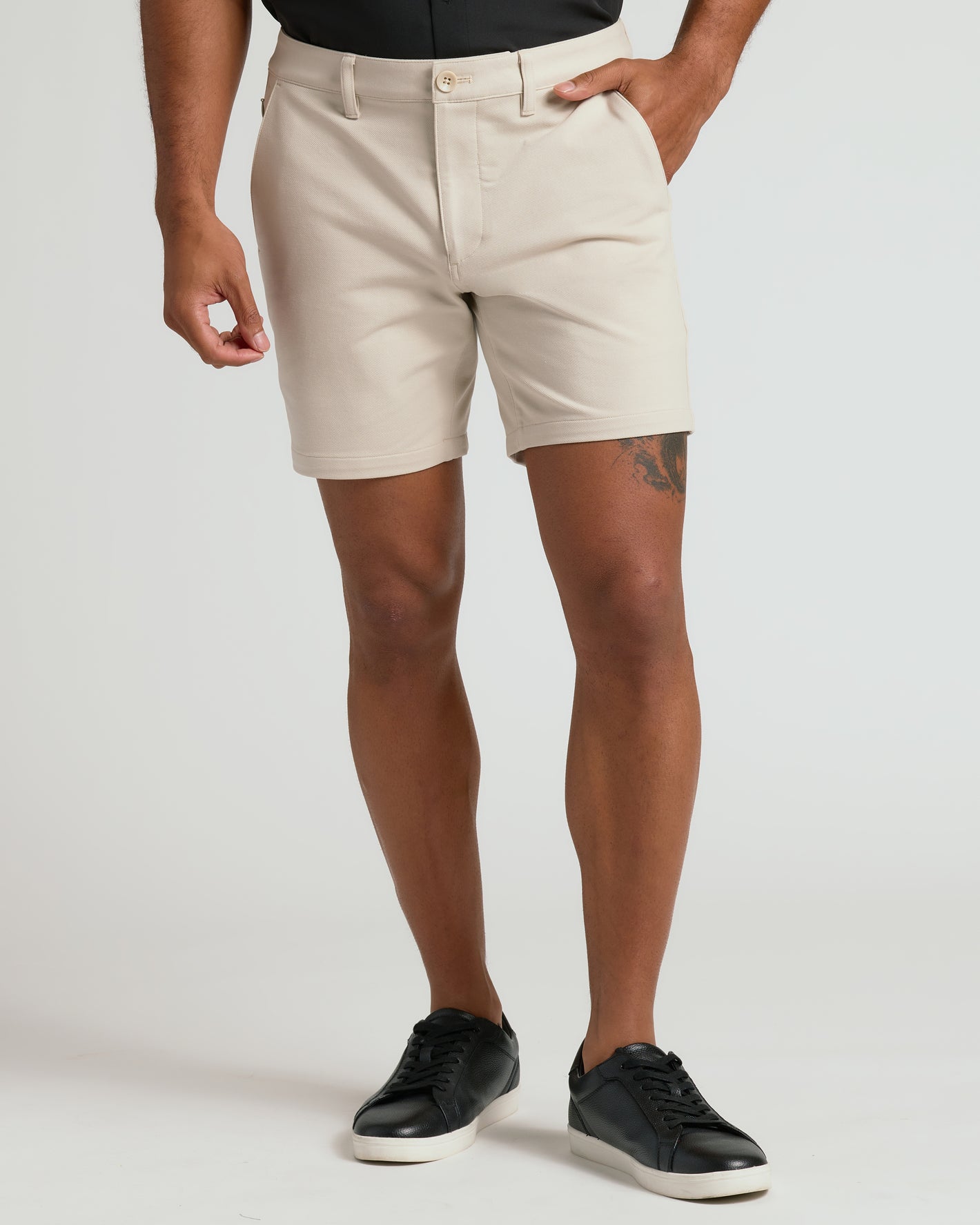Model wearing 7 Sandstone Chino Shorts 2.0 with sneakers.