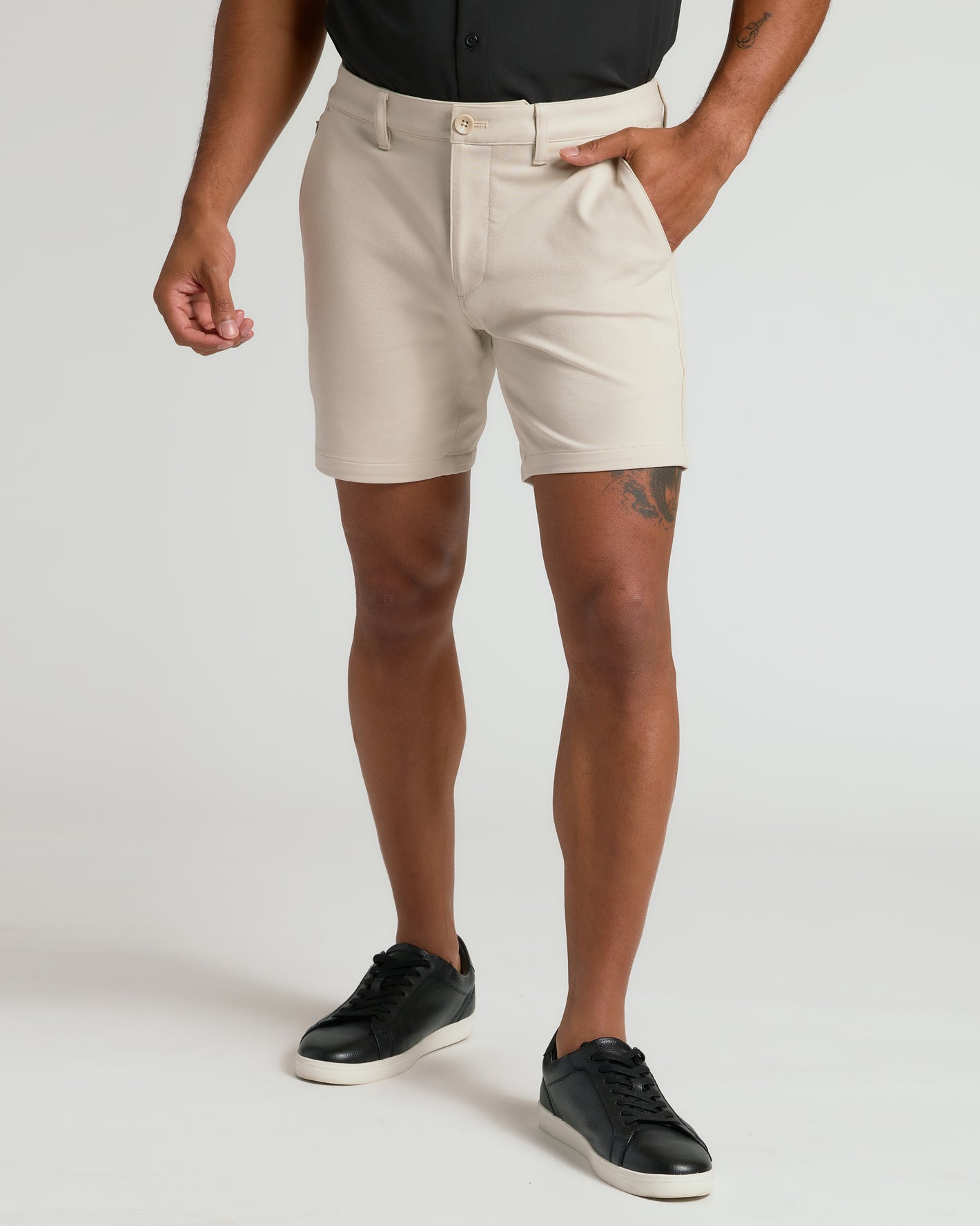 7 Sandstone Chino Shorts 2.0 with side pockets and black sneakers.