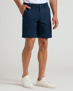 True Classic9 Navy Linen Shorts worn with white sneakers, hand in pocket.