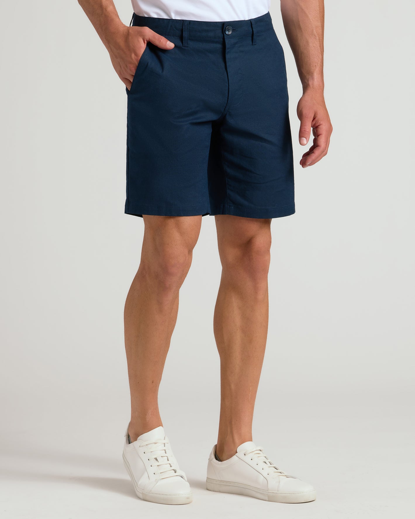 9 Navy Linen Shorts worn with white sneakers, hand in pocket.