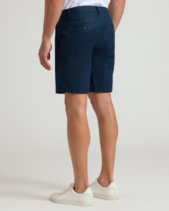 True Classic9 Navy Linen Shorts paired with white sneakers and a tucked-in shirt.