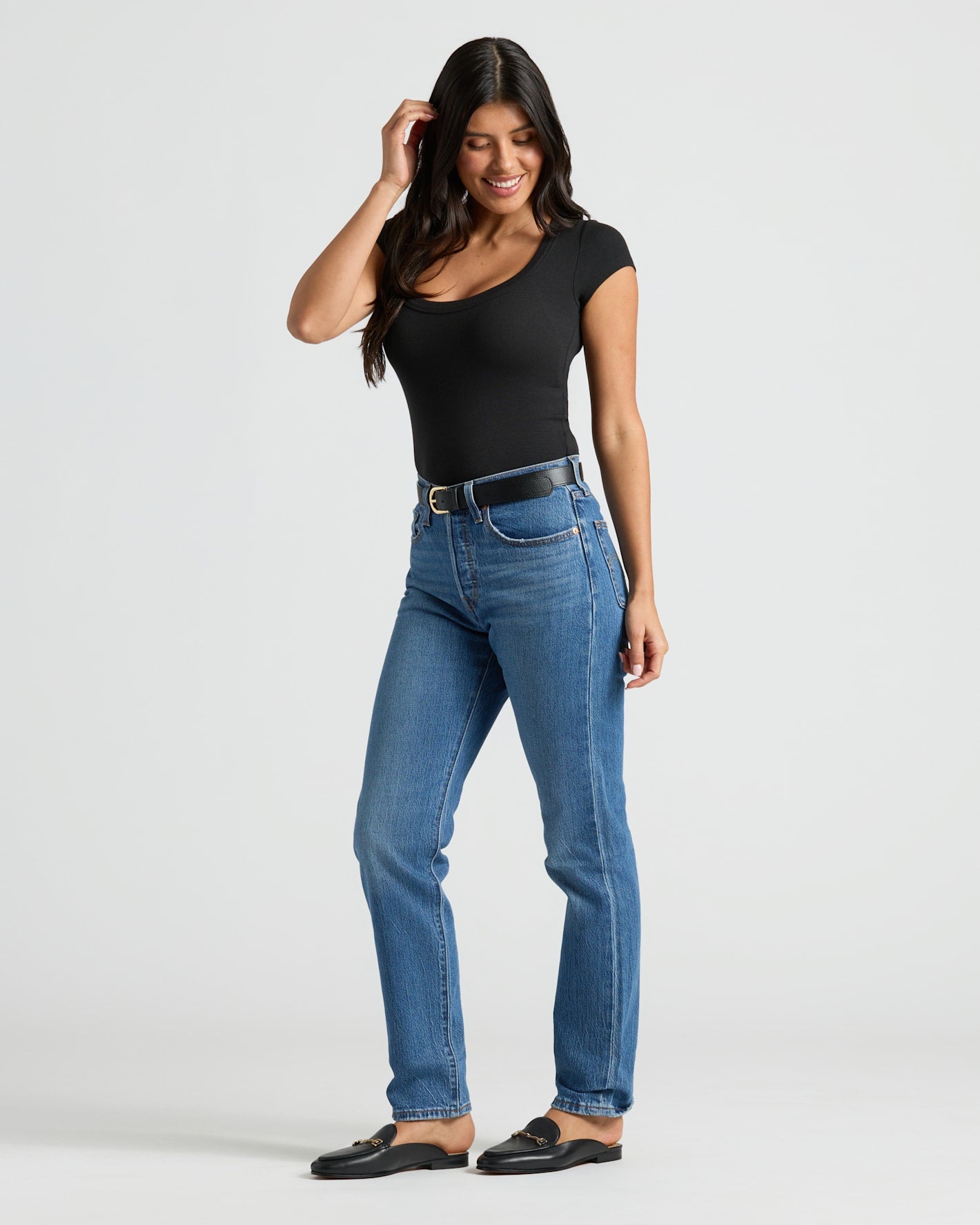 Woman wearing Womens Ribbed U-Neck Tee in black, styled with jeans and loafers.