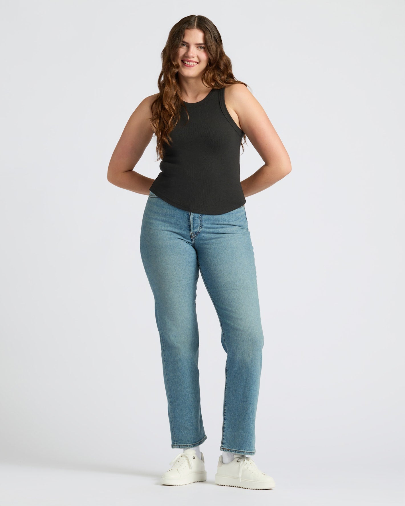Womens Black Ribbed High Neck Tank worn by smiling woman, casual style.