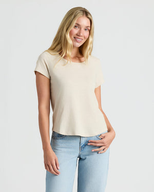 Woman wearing Womens Oatmeal Slub Scoop Neck Tee 4-Pack, smiling gently. MODEL_INFO: Sophia is 5'10", wearing a size S