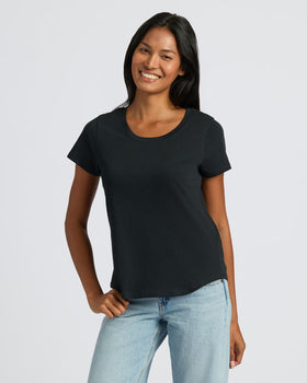 Woman wearing Womens Black Slub Scoop Neck Tee with jeans, smiling.
