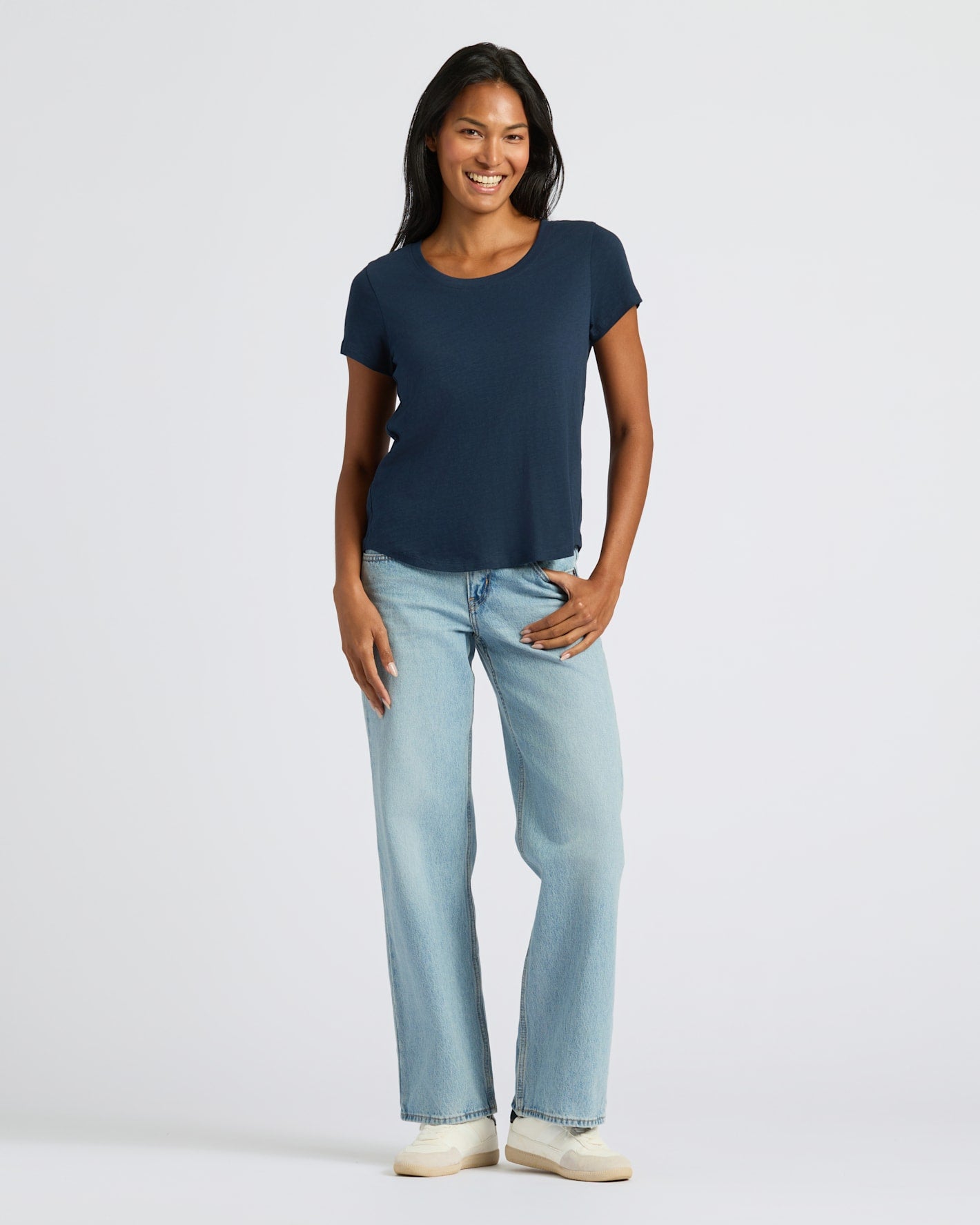 Woman wearing Womens Navy Slub Scoop Neck Tee with jeans and sneakers.