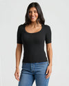 Woman in Womens Black Ribbed 3/4 Sleeve Scoop Neck Tee, smiling.