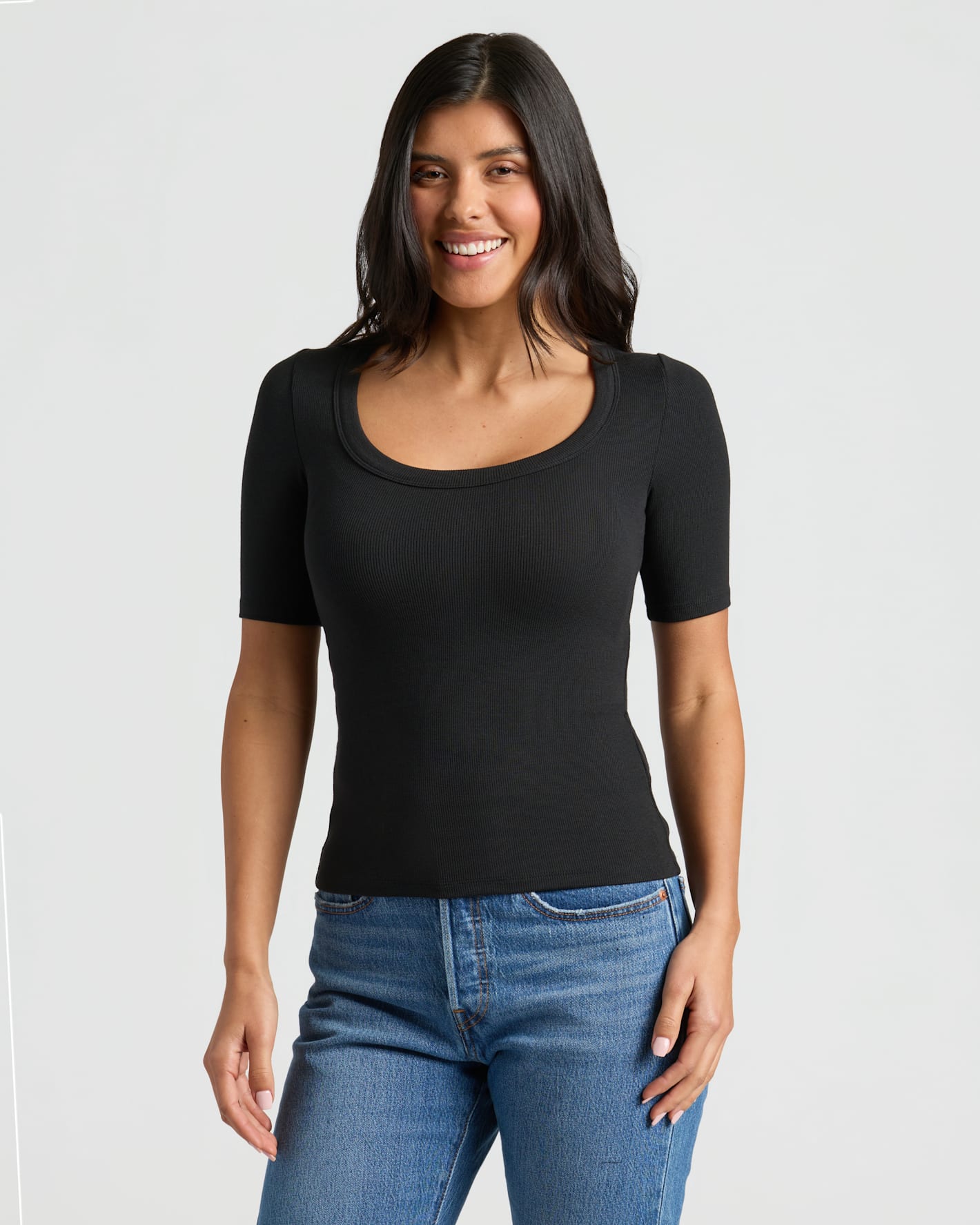 Woman in Womens Black Ribbed 3/4 Sleeve Scoop Neck Tee, smiling.
