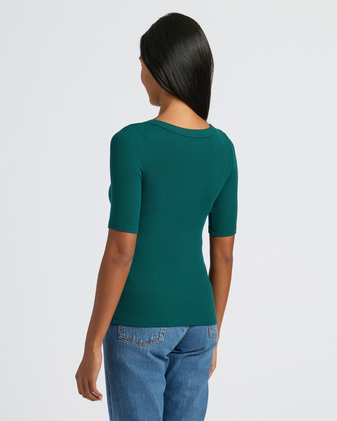 Woman wearing Womens Deep Emerald Ribbed 3/4 Sleeve Scoop Neck Tee from back.