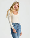 Woman in Womens Ribbed Long Sleeve Scoop Neck Tee, smiling in light-wash jeans. MODEL_INFO: Cora is 5'10", wearing a size S 