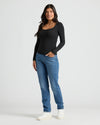 Woman wearing Womens Ribbed Long Sleeve Scoop Neck Tee, blue jeans, white sneakers.