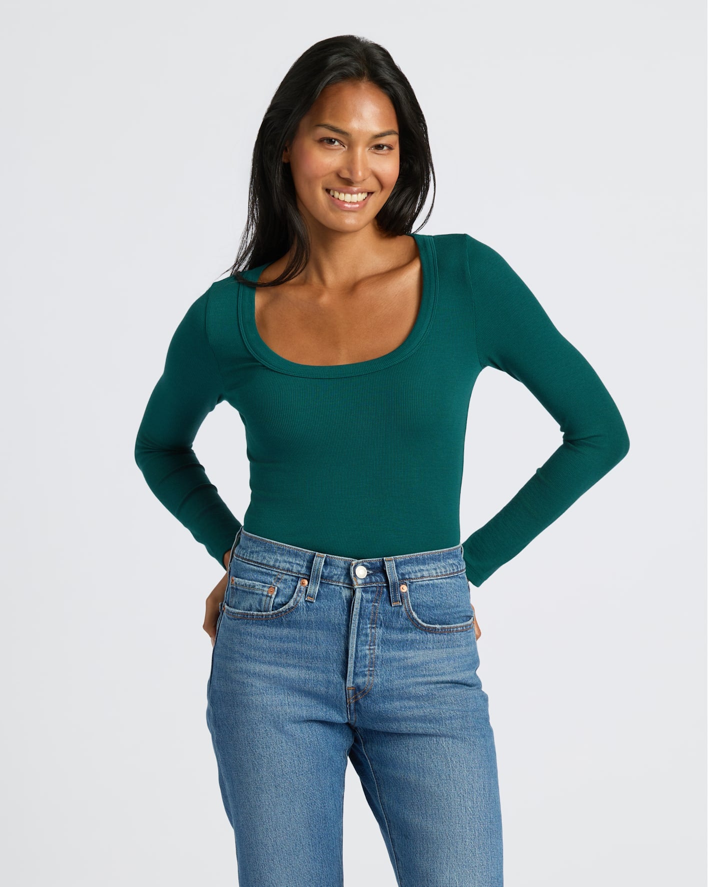 Young woman wearing Womens Deep Emerald Ribbed Long Sleeve Scoop Neck Tee.