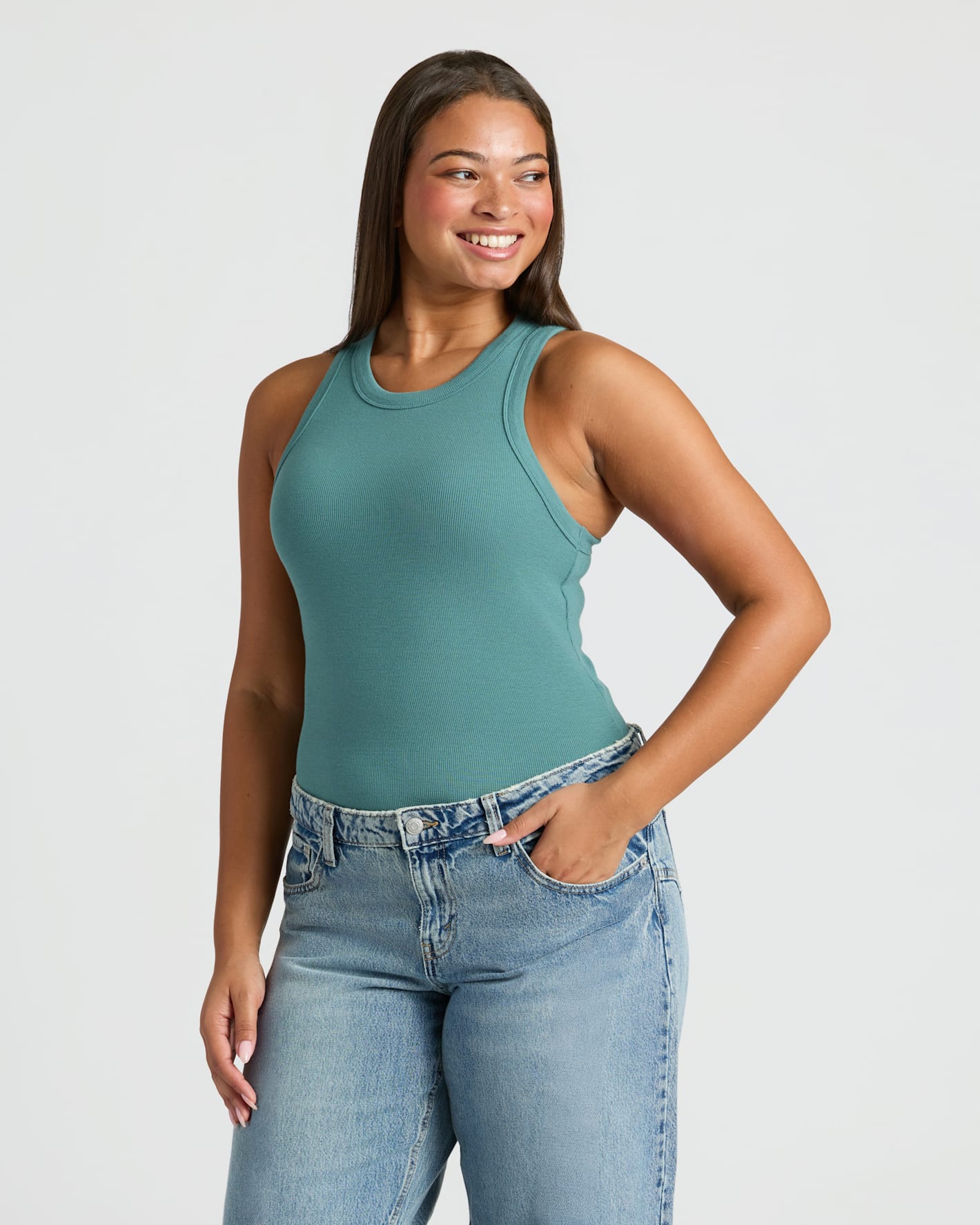 Young woman wearing Womens Stormcloud Ribbed High Neck Tank and jeans.