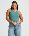 Young woman in Womens Ribbed High Neck Tank, teal, with jeans.