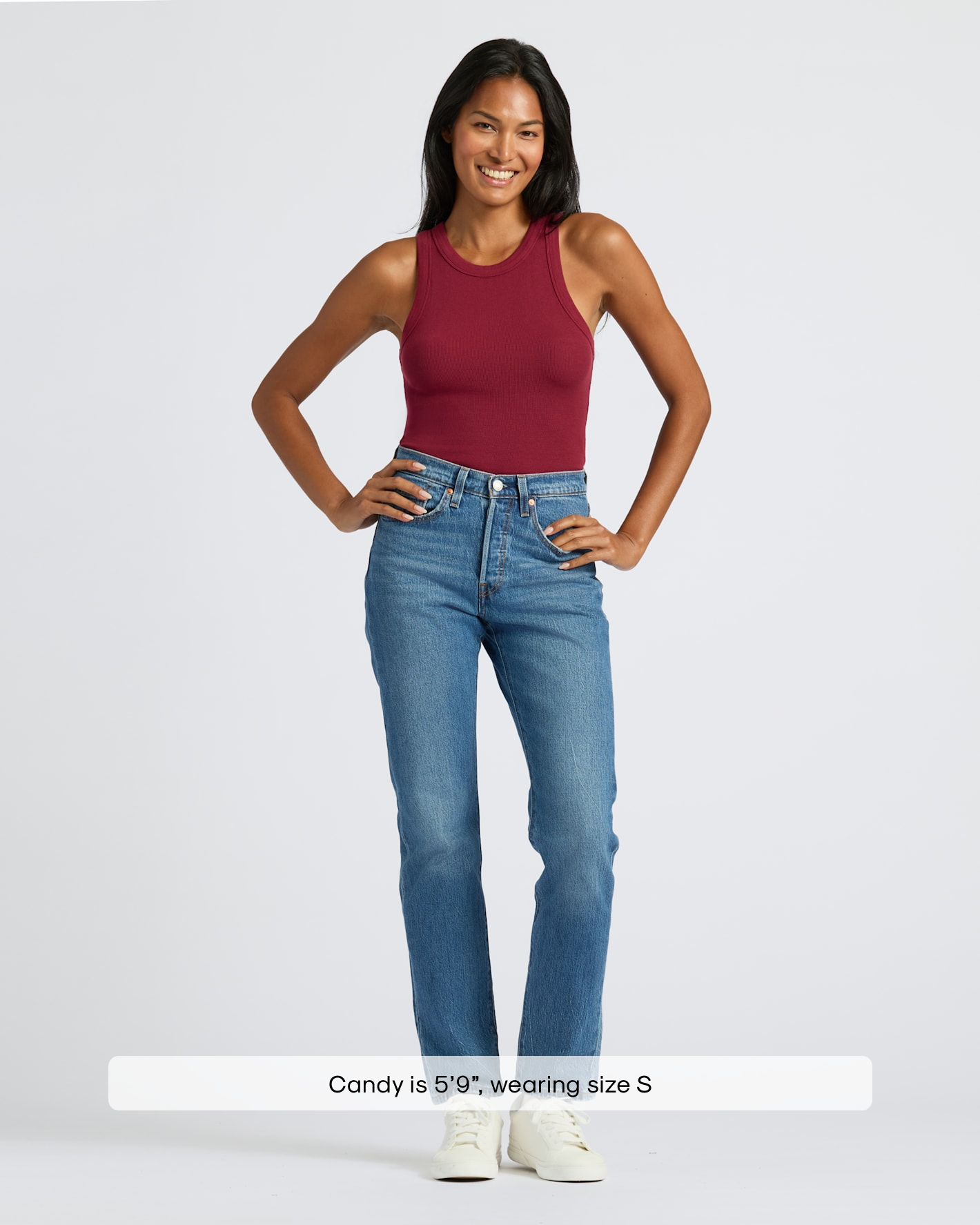 Woman in Womens Dark Maroon Ribbed High Neck Tank, jeans, sneakers.