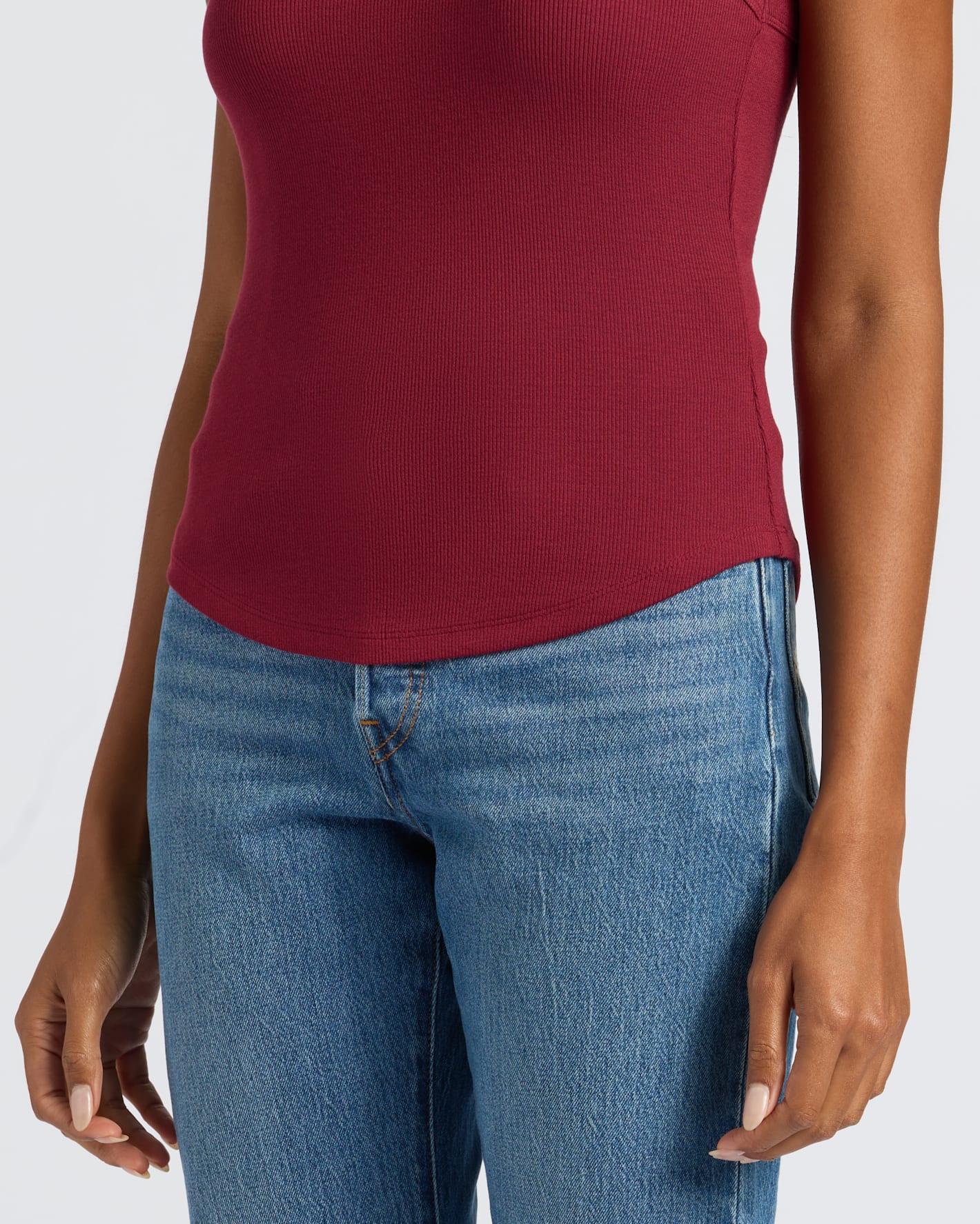 Womens Dark Maroon Ribbed High Neck Tank with light-wash jeans.