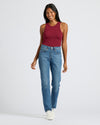 Woman in Womens Dark Maroon Ribbed High Neck Tank with jeans, smiling.