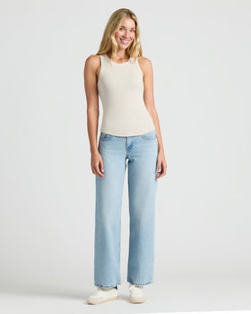 Woman in Womens Ribbed High Neck Tank 3-Pack, smiling in casual jeans and sneakers.