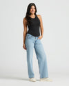 Young woman in Womens Ribbed High Neck Tank, fitted and stylish. MODEL_INFO: Sophia is 5'8", wearing a size XS