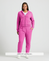 Woman modeling Womens Electric Fuchsia Relaxed Joggers with zip-front hoodie.
