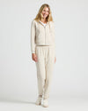 Woman in Womens Oatmeal Crop Zip Hoodie, smiling in loungewear set.