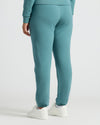 Womens Stormcloud Relaxed Joggers with elastic cuffs and white sneakers.