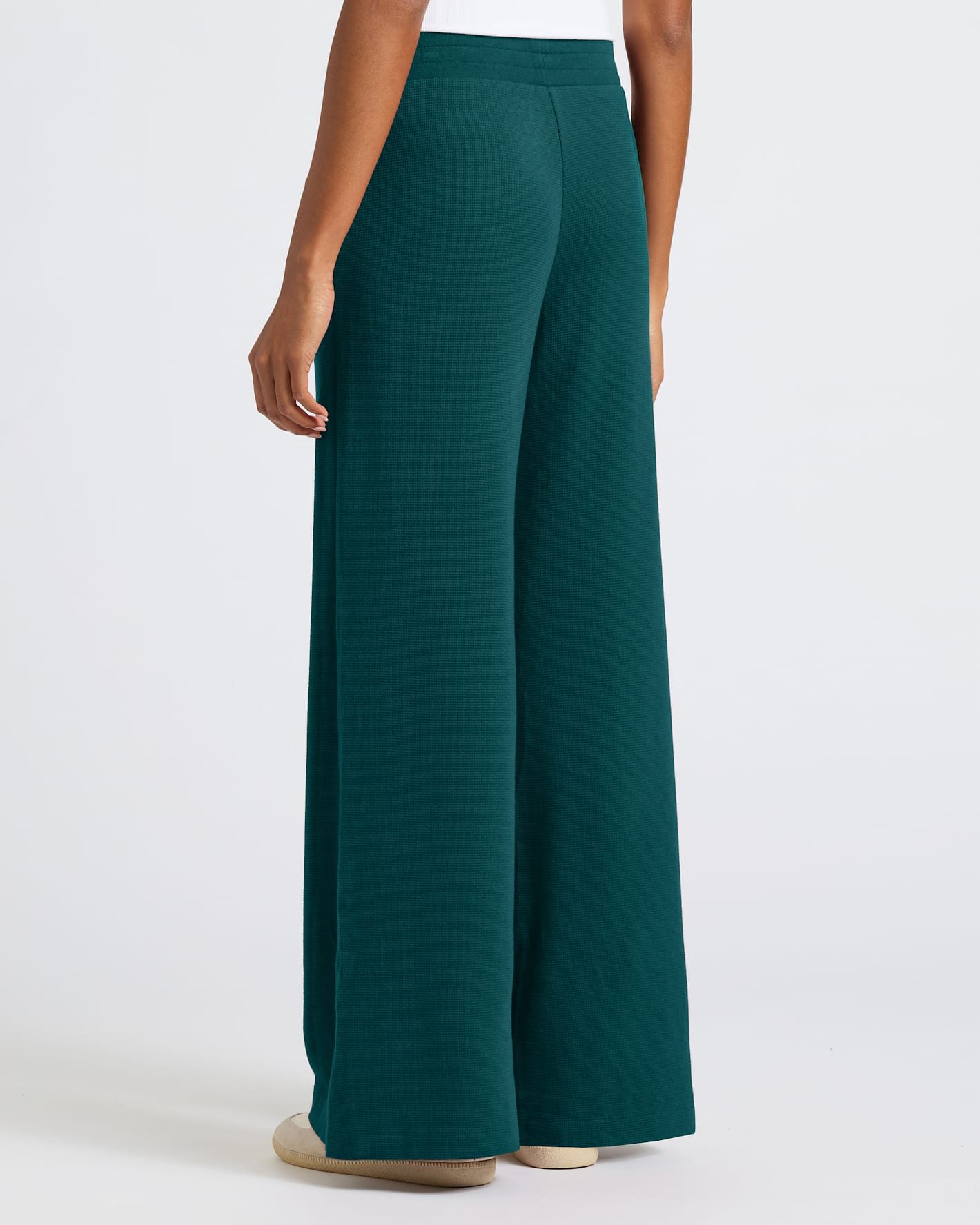 Woman modeling Womens Deep Emerald Waffle Wide Leg Pants, back view.