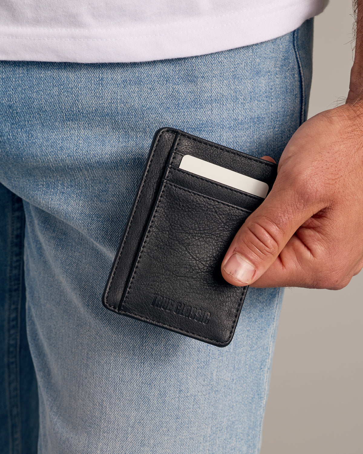 Black Classic Wallet in hand, showcasing vegan leather and card slots.