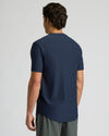 Man wearing a navy blue t-shirt on a light gray background
