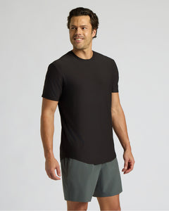 True ClassicMan wearing a black t-shirt and gray shorts on a light gray background