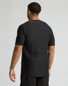 Man wearing a black t-shirt on a light gray background