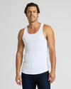 Man wearing a white tank top against a plain background
