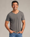 Man wearing Carbon Green Classic V-Neck from 6-Pack, smiling casually.
