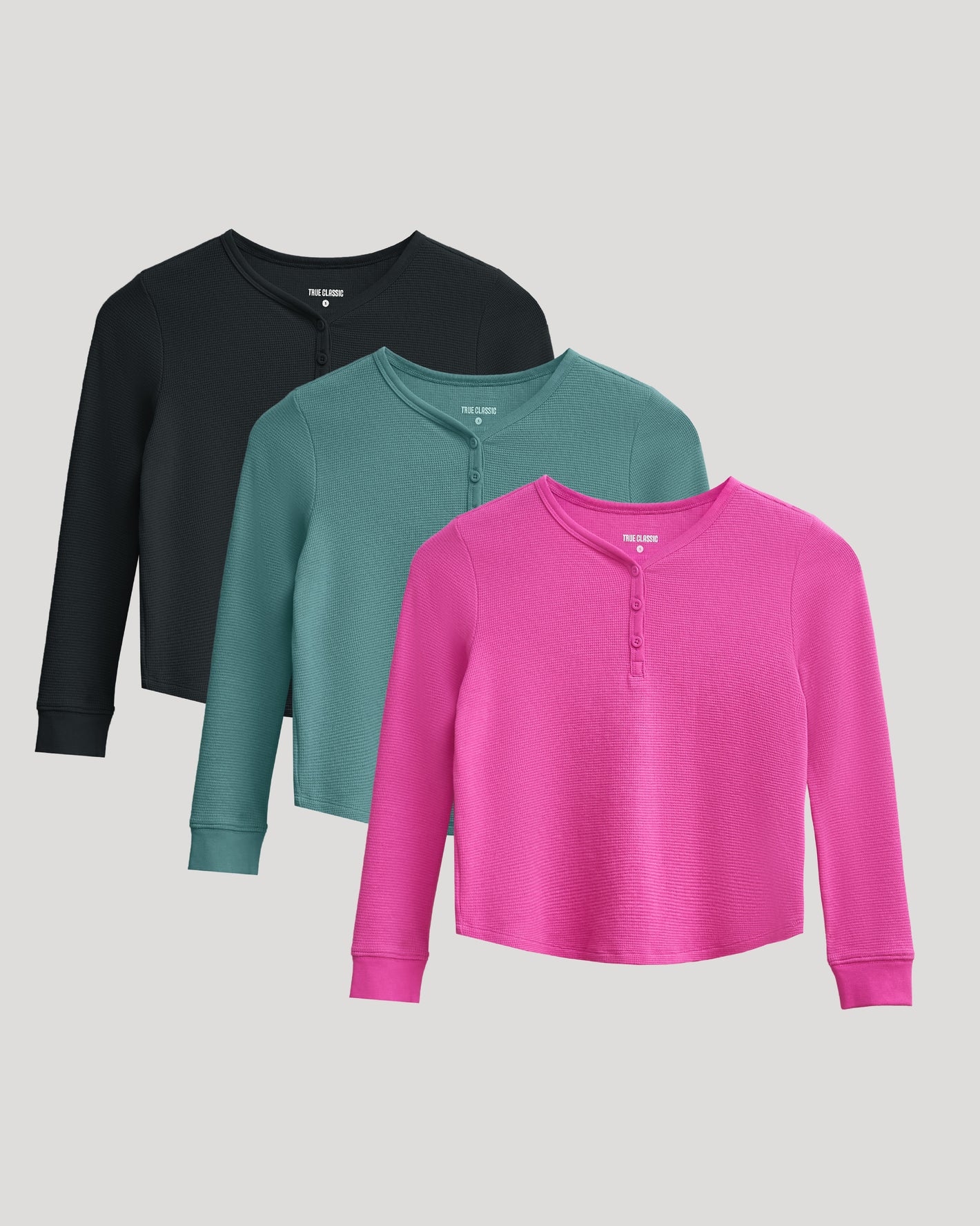 Girls Long Sleeve Boxy Waffle Henley 3-Pack overlapping in black, teal, pink.