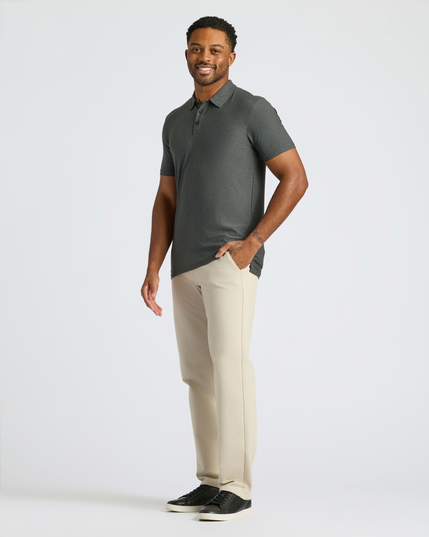 Man models True Classic Men’s Classic Short Sleeve Polo Shirt, showcasing its fit.