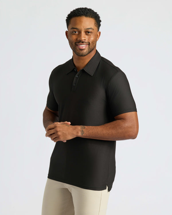 Black Active Polo 2.0 worn by smiling man with tattoo.