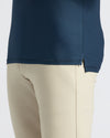 Navy Active Polo 2.0 with side slit, paired with light-beige pants.