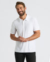 Man wearing White Active Polo 2.0, smiling, hands clasped.