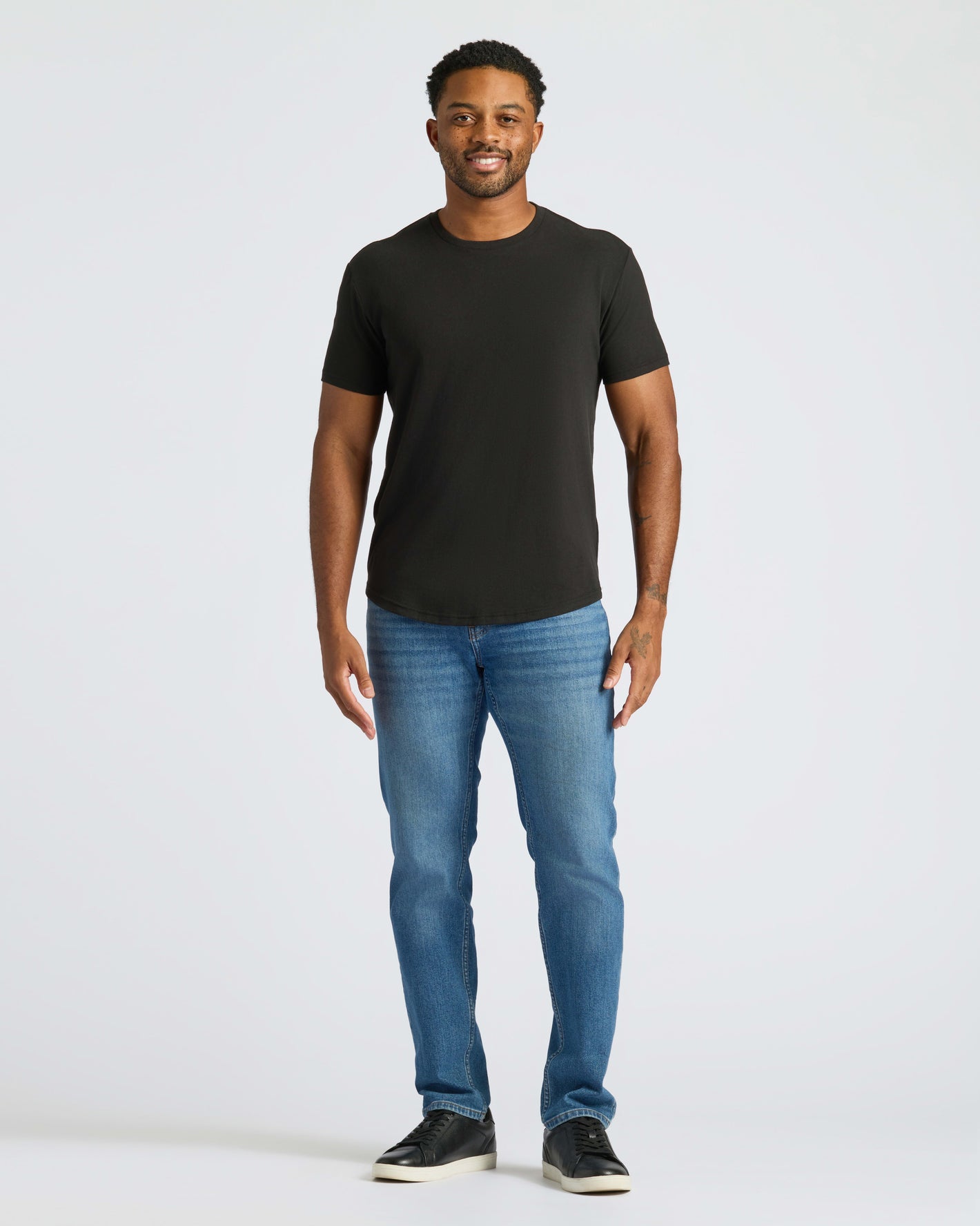 Man wearing All Black Curved Hem Classic Crew Neck T-shirt.