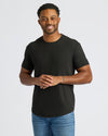 Man modeling All Black Curved Hem Classic Crew Neck, showcasing fit and design.