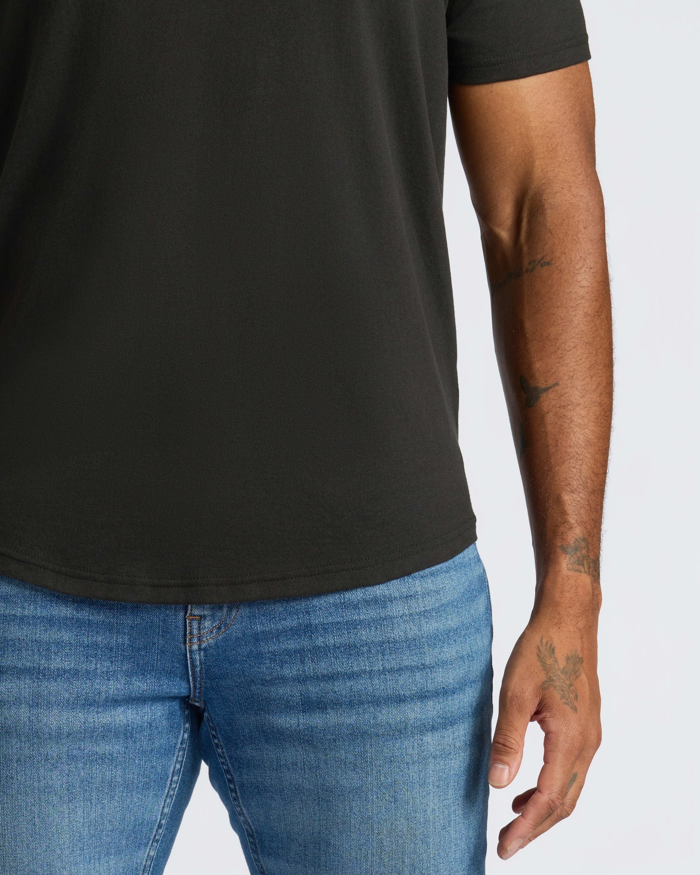 All Black Curved Hem Classic Crew Neck 10-Pack on tattooed arm.