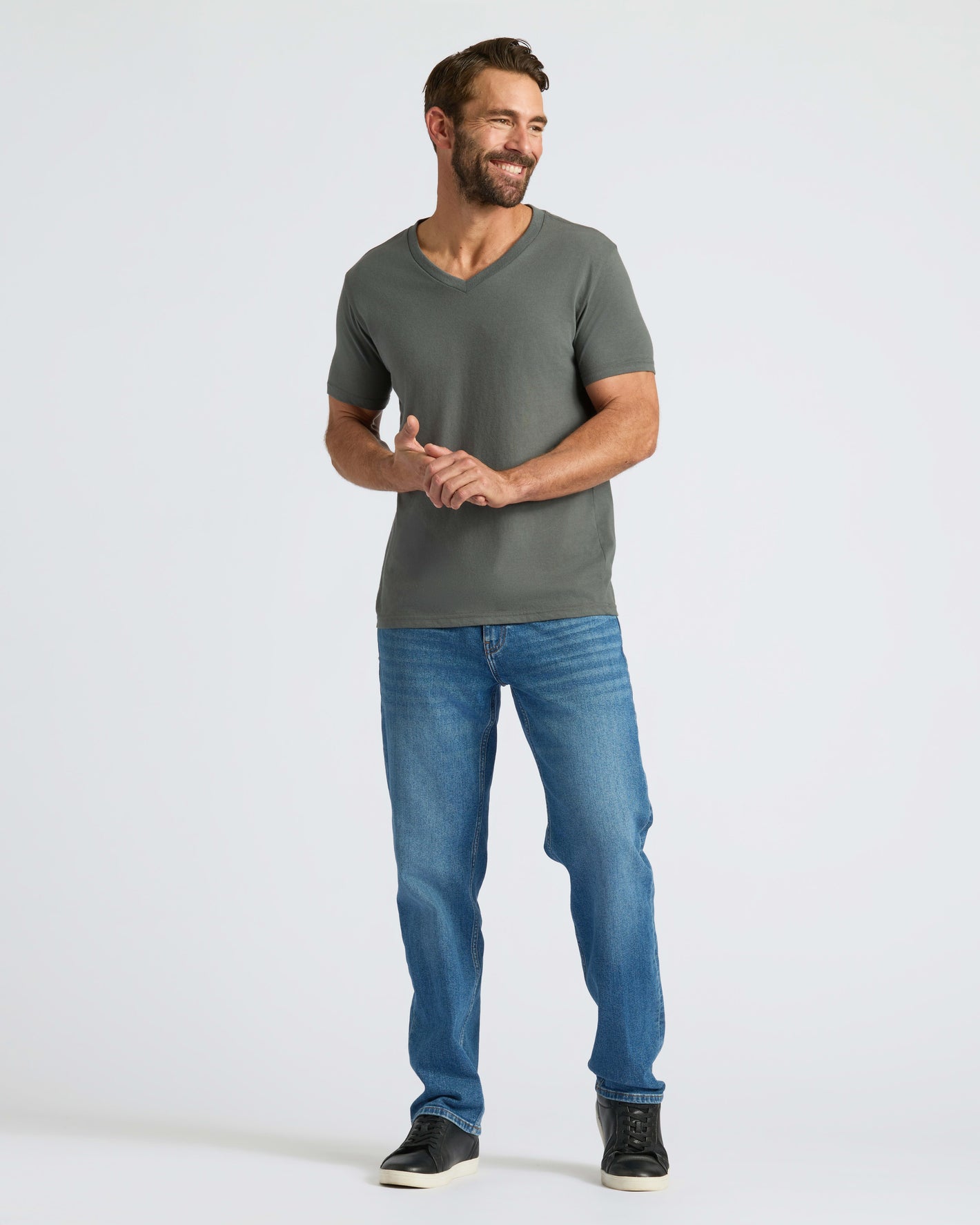 True Classic Men’s V-Neck T Shirt worn by smiling man, relaxed pose.