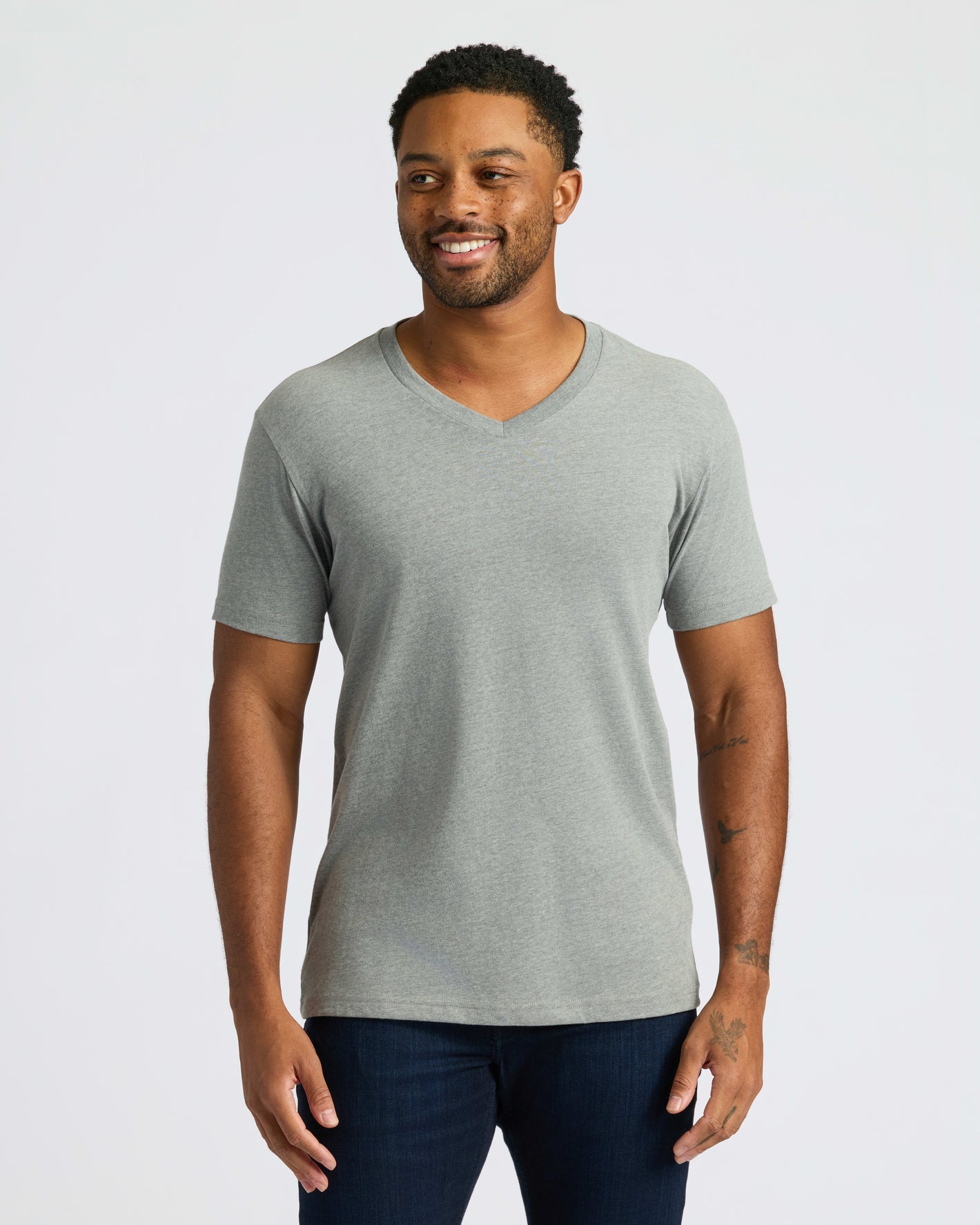 True Classic Men’s V-Neck T Shirt on smiling man with tattoos.