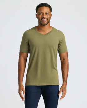 Man wearing Classic V-Neck T-shirt and jeans, smiling.
