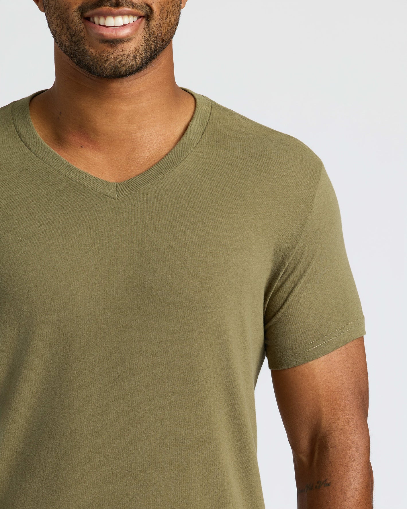 Man wearing Classic V-Neck T-shirt with tattoo on forearm.