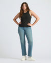 Woman modeling Womens Black Ribbed High Neck Tank 3-Pack with light-wash jeans.