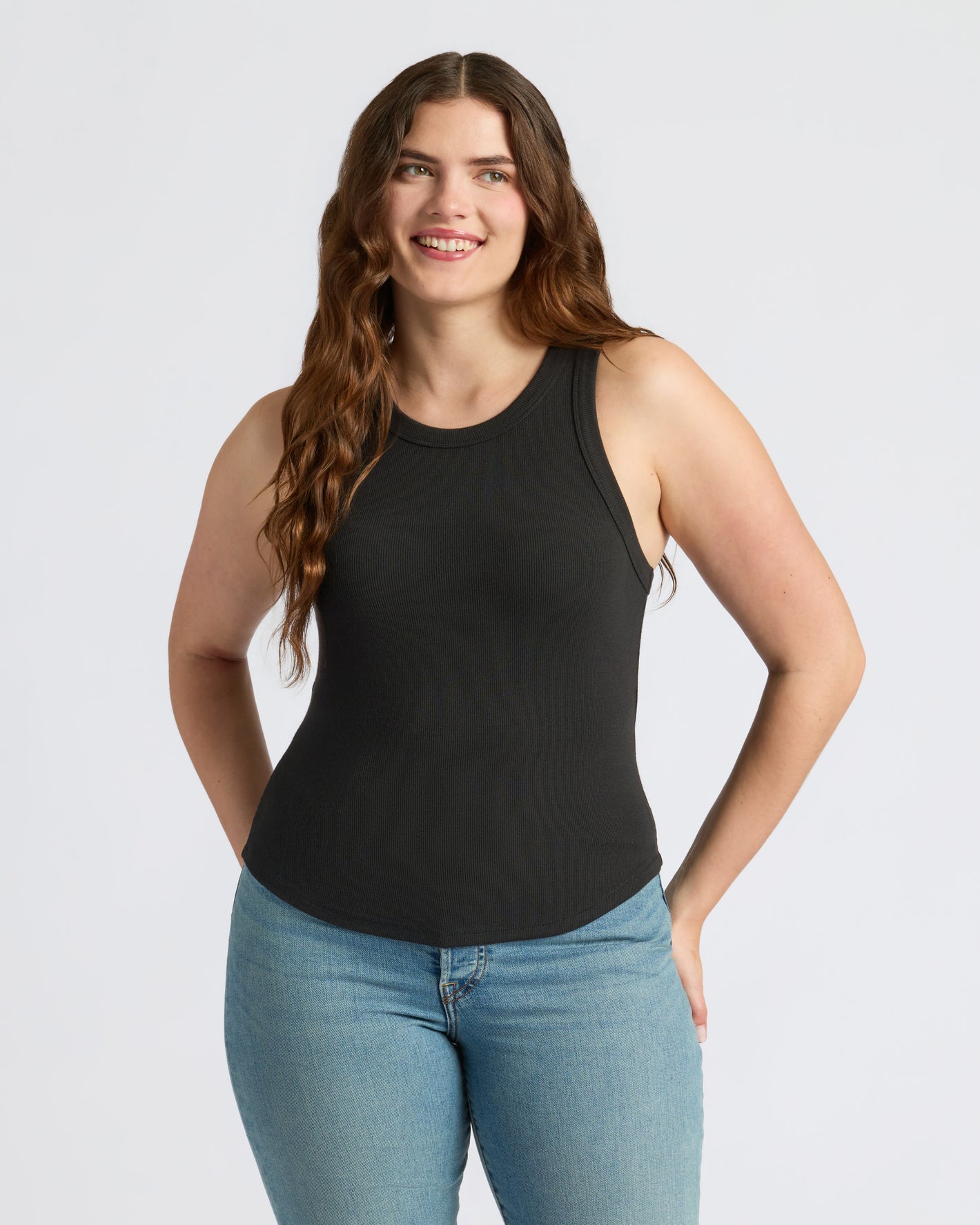 Woman models Womens Black Ribbed High Neck Tank 3-Pack, showcasing its sleek fit.