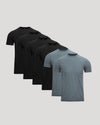 Six short-sleeve crew-neck t-shirts arranged in a fan shape on a light gray background, showing color options from black to heather gray.