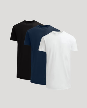 Three classic men's crew neck t-shirts in black, navy, and white, styled as True Classic Men's Tall Heavyweight Curved Hem Crew – Premium Heavyweight Cotton Blend, Extended Length, Athletic Fit, Structured Everyday T-Shirt.